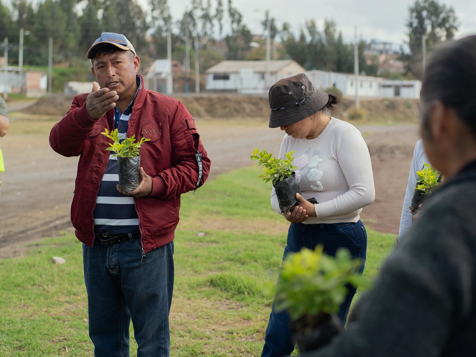 Participantes con plantas durante una jornada junto a la laguna.